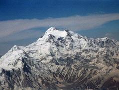
The flight from Islamabad to Skardu continues to fly around Nanga Parbat with Hermann Buhl�s route of first ascent becoming perfectly visible. Rakhiot Peak leads up to the Silver Saddle between the Nanga Parbat Southeast and East Peaks, and up to the summit with the North Peaks on the right.
